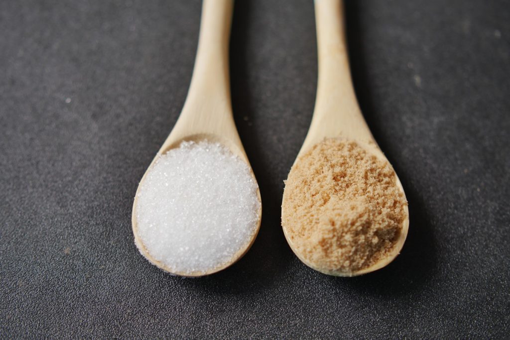 Comparing white and brown sugar on spoon